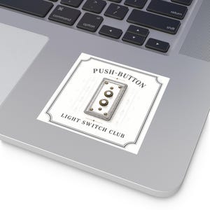 May include: A square sticker featuring a vintage-style rectangular light switch plate with two round push buttons. The design includes a decorative border and the text PUSH-BUTTON LIGHT SWITCH CLUB in black lettering on a white background.