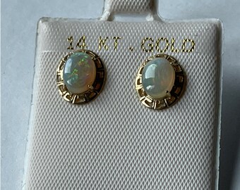 Opal post earrings in 14 karat gold filigree style celtic design