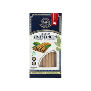 May include: A rectangular product box for 94 Origin Ceylon Zimtstangen featuring a dark blue top section with a gold logo and a white lower section displaying a pile of cinnamon sticks, green leaves, and a clear window showing 50 grams of product.