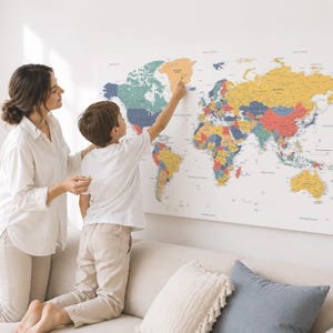May include: A large, rectangular wall map of the world featuring a colorful, multi-toned design with distinct shades of yellow, blue, green, and red representing different countries and continents, printed on a white background with clear text.