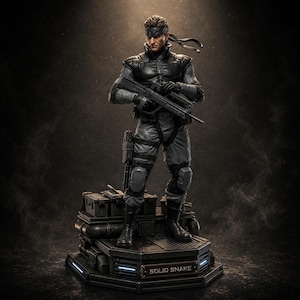 Op de afbeelding: Een gedetailleerd verzamelbeeldje van Solid Snake dat op een tactische basis staat. Het personage draagt een zwart en grijs tactisch pak met een hoofdband en houdt een geweer vast. De basis heeft een naamplaatje met de tekst SOLID SNAKE.