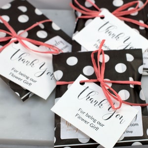 May include: Four black and white polka dot gift bags with pink ribbon and white thank you tags that read "Thank You for being our Flower Girl!"