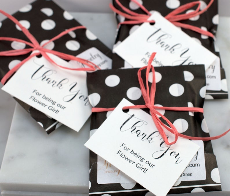 May include: Four black and white polka dot gift bags with pink ribbon and white thank you tags that read "Thank You for being our Flower Girl!"