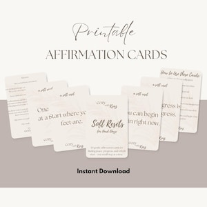 May include: A set of printable affirmation cards featuring the text "Soft Resets for Hard Days" and "cozy with Kenz" branding. The cards are off-white with dark brown text and a subtle palm leaf graphic. The set includes instructions and various phrases.