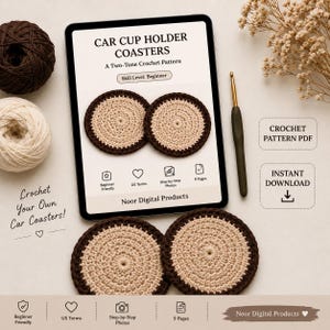 May include: A digital tablet displays a crochet pattern for car cup holder coasters with text reading CAR CUP HOLDER COASTERS, A Two-Tone Crochet Pattern, and Skill Level: Beginner. Two round, two-tone beige and dark brown crochet coasters sit below the tablet, accompanied by a crochet hook, yarn balls, and text indicating a PDF download.