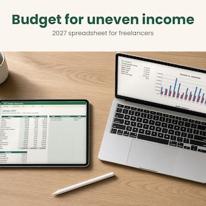 May include: A digital budget spreadsheet for freelancers titled Budget for uneven income 2027 displayed on a laptop and tablet screen. The screens show financial tables and an income versus expenses bar chart. A white stylus and mug are present.