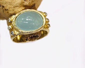 Aquamarine cabochon , 14 krat yellow gold handmade ring with diamonds