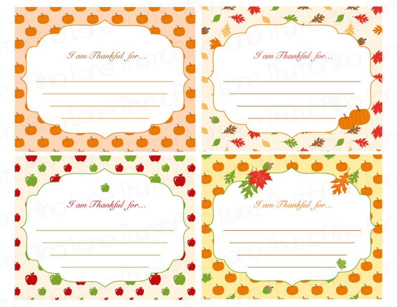 May include: Four printable cards with a fall theme. Each card has a white frame with the text "I am Thankful for..." and a space for writing. The cards are decorated with a pattern of pumpkins, apples, and leaves.