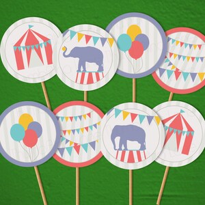 May include: Set of eight printable circus party cupcake toppers. The toppers feature a red and white striped tent, a purple elephant on a red and white striped platform, a string of colorful flags, and balloons in purple, yellow, and blue.