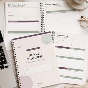 May include: A spiral-bound Novel Planner workbook with a light beige cover featuring purple and green circular accents and small bird illustrations. The cover displays the text Novel Planner, Plan the story, Build the world, Finish the book, and That Tracks.