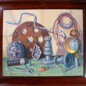 May include: An oil painting of various automotive parts, including gears, a flywheel, and a wrench, arranged on a green surface. The artwork is framed in a dark brown wooden frame. The color palette includes shades of brown, blue, and silver.