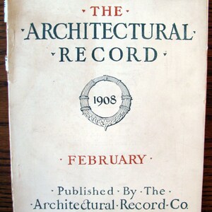 May include: Cover of "The Architectural Record" from February 1908, featuring text in black and red. The title is in large, stylized letters. The cover also includes the text "Brooklyn Plaza and the Projected Brooklyn Central Library."