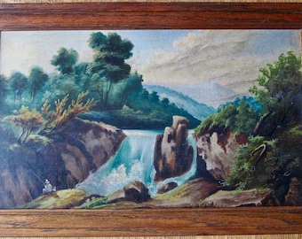 May include: An oil painting of a waterfall scene, framed in a dark wood. The artwork depicts a cascading waterfall with a figure fishing on the bank. Lush green trees and foliage surround the waterfall, with mountains in the background.