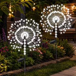 May include: Two outdoor garden lights shaped like dandelion seed heads, featuring thin, radiating wire stems topped with small, glowing white LED bulbs. Each light is mounted on a slender black stake with a circular solar panel at the base.