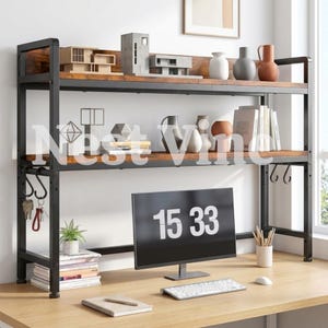 May include: A two-tier desk hutch with a black metal frame and wood-grain shelves. The unit features side hooks, a computer monitor displaying 15 33, a keyboard, a notebook, books, vases, and architectural models. The word Nest Vine is overlaid.