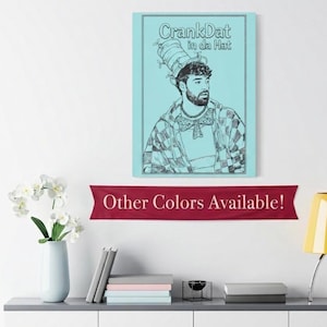May include: A rectangular wall art print featuring a light blue background and a black line drawing of a person wearing a tall striped hat and a bow tie. The text "CrankDat in da Hat" is printed in black at the top of the illustration.