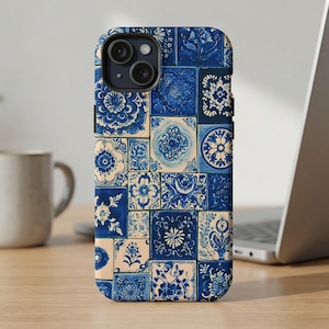 May include: A smartphone case featuring a collage of square tiles in shades of deep blue and cream. The design displays various intricate floral and geometric patterns, including circular motifs, botanical illustrations, and symmetrical shapes.