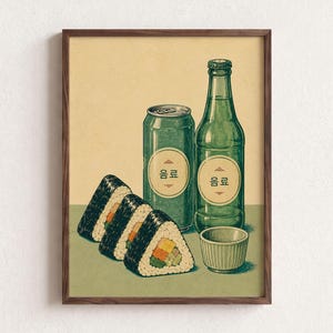 May include: A framed illustration featuring three triangular rice balls with visible fillings, a green aluminum can, a green glass bottle, and a small cup. Both the can and bottle feature circular labels with the Korean text 음료 printed in black.
