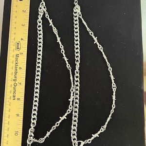 Barbed wire and chains, silver.  Bootlets, bling for your boots.