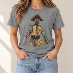 May include: A grey short-sleeved t-shirt featuring a graphic illustration of a zombie pirate. The character wears a brown tricorn hat, a yellow vest with red blood stains, and a dark belt. The pirate has a distressed appearance with tattered clothing.