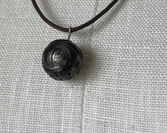 Leather necklace with genuine Tahitian pearl carved with Maori tattoo tribal symbol, folklore, leather necklace, craftsmanship