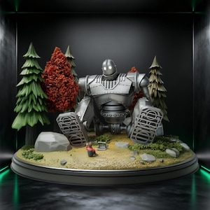 May include: A silver-colored robot figurine with glowing white eyes sits on a circular base. The scene includes miniature green and orange trees, grey rocks, and a small figure sitting on the ground, all arranged in a forest-like setting.