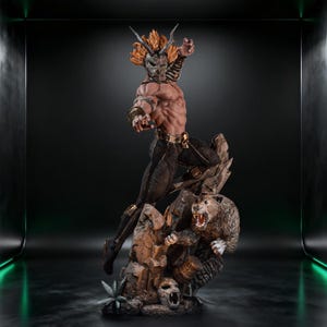 May include: A detailed collectible statue of a muscular warrior figure wearing a horned mask and dark pants with gold accents, posed dynamically on a rocky base alongside a snarling leopard, featuring intricate textures and a bronze-toned finish.