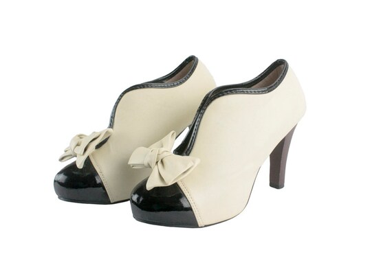 cream and black pumps