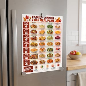 May include: A rectangular magnetic chart titled Family Dinner 7 Day Meal Plan with a fall theme featuring autumn leaves and a pumpkin. The grid displays seven days of the week with columns for main dishes, sides, veggies, and desserts with food photos.