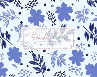 Puede incluir: Un patrón continuo con siluetas florales azules, ramas de hojas esbozadas en azul oscuro y pequeños puntos sobre un fondo azul claro. Una etiqueta rectangular central contiene el texto Seamless Pattern, JPG 300DPI, 12x12 IN.