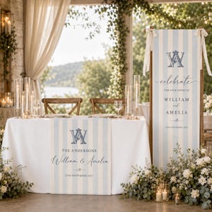 May include: A wedding table runner and a vertical standing banner featuring light blue and white vertical stripes. Both items display a dark blue monogram with the letters WA, the text The Andersons, William & Amelia, and 12th September 2027.