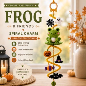 May include: A crochet pattern PDF titled Frog & Friends Spiral Charm Halloween Edition. The hanging decoration features a green frog, a white ghost, a black spiderweb, an orange pumpkin, a black witch hat, a candy, and a black bat on a yellow spiral.