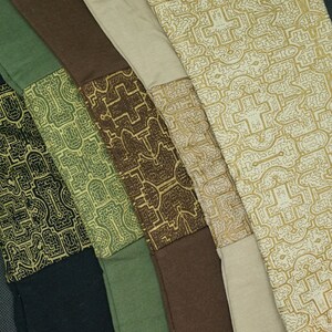 May include: Five fabric swatches with a geometric pattern in shades of brown, green, and beige. The fabric is woven with a subtle texture.