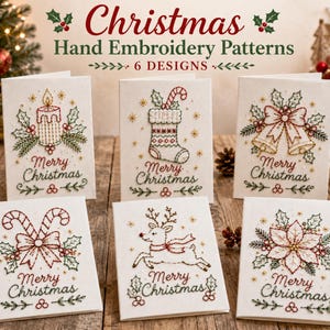 May include: Six white greeting cards featuring Christmas hand embroidery patterns including a candle, stocking, bells, candy canes, reindeer, and poinsettia. Each card displays the text Merry Christmas in red and green stitched lettering.
