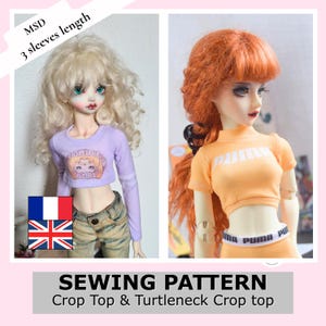 May include: Two ball-jointed dolls wearing crop tops. The left doll has blonde hair and a lavender long-sleeve shirt with the text "FIGHT LIKE A GIRL". The right doll has orange hair and an orange short-sleeve shirt with the text "PUMA" and matching waistband.