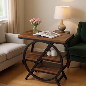 May include: A side table featuring a dark wood grain rectangular top and two lower shelves supported by a black metal frame with a large circular design. The table holds an open book, a glass vase with pink flowers, and two small white containers.