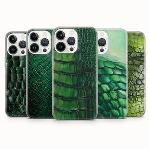 May include: Five smartphone cases arranged in a row, each featuring a distinct green reptile skin texture. The designs range from dark forest green scales to lighter, lime-toned patterns, all showcasing a realistic, textured appearance.