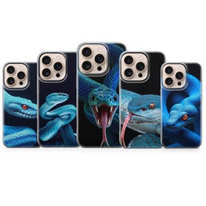 May include: Five smartphone cases arranged in a row, each featuring a high-resolution graphic of a vibrant blue snake against a dark background. The designs display various poses of the snakes, including one with an open mouth and visible tongue.