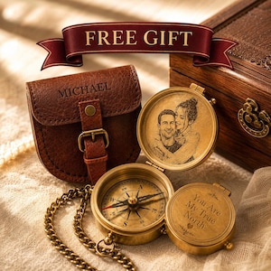 May include: A brass compass with a chain, featuring an engraved portrait of a couple inside the lid and the text "You Are My True North" on the inner cover. It includes a brown leather pouch embossed with the name "MICHAEL" and a wooden box.