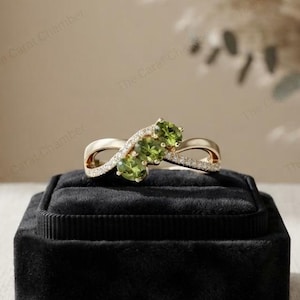 Gouden oneindigheidsring, drie groene edelstenen, accentstenen, sieraden geïnspireerd op de natuur