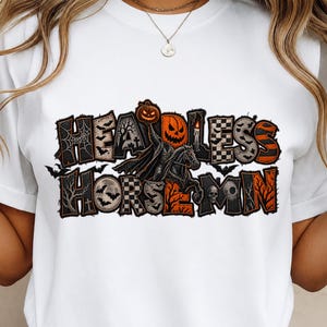 May include: A white t-shirt featuring a graphic print with the text HEADLESS HORSEMAN. The design includes a black horse, a pumpkin head, bats, a skull, a spider web, and a candle, all rendered in a distressed orange, black, and white colour palette.