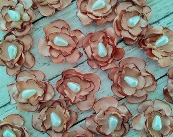 1 inch rose gold colored satin flower embellishments with faux pearl center