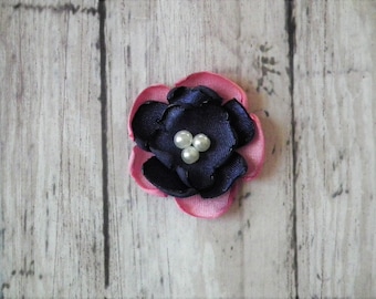 1 inch carnation and navy satin flower embellishments, with faux pearl centers