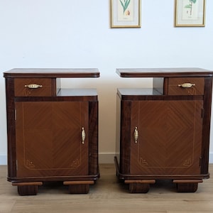 May include: A pair of wooden bedside tables featuring a dark brown finish, each with one small upper drawer and a lower cabinet door. The cabinet doors display a light brown diamond-patterned veneer with gold-toned metal handles and hinges.