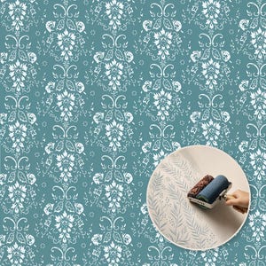 May include: A teal wallpaper featuring a repeating white damask pattern with stylized floral and leaf motifs. A circular inset shows a blue patterned paint roller applying a light gray fern-like design onto a plain off-white surface.