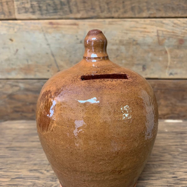 Handmade pottery coin bank, red clay slipware in amber glaze