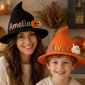 May include: A black witch hat with the name Amelia embroidered in rainbow letters and a small pumpkin appliqué, and an orange witch hat with the name Oliver embroidered in rainbow letters and a small ghost appliqué, both featuring pointed crowns.