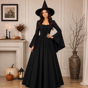 May include: A floor-length black dress with long bell sleeves and a lace-up corset-style bodice, paired with a matching pointed witch hat. The garment features a square neckline and a full, flowing skirt, creating a cohesive dark ensemble.
