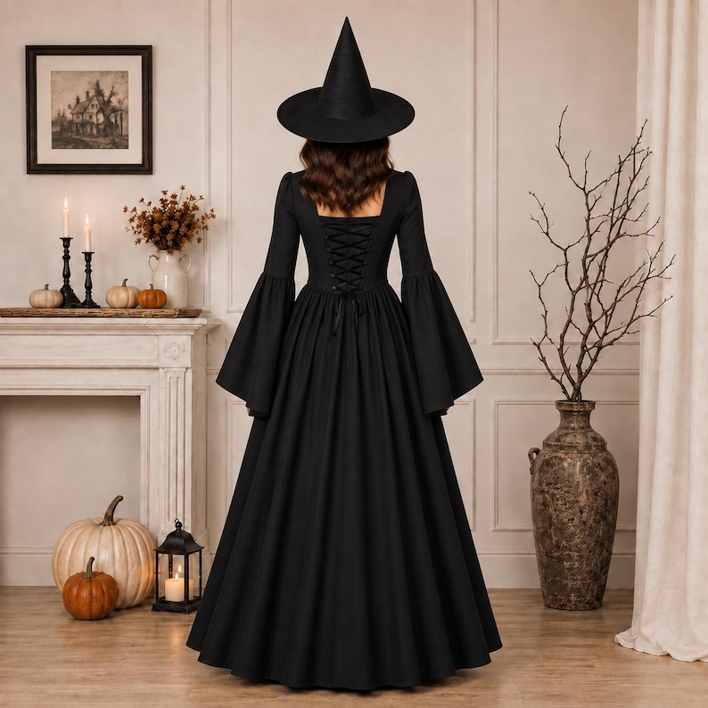 May include: A floor-length black dress with long flared sleeves and a lace-up corset back, paired with a tall pointed black witch hat. The garment features a fitted bodice that transitions into a full, flowing skirt, creating a silhouette.