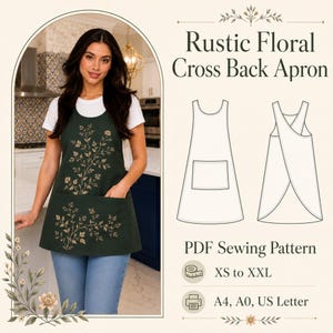 Könnte beinhalten: Eine dunkelgrüne Schürze mit überkreuzten Trägern, weißem Blumenmuster, Vordertasche und weißem T-Shirt. Das Bild enthält den Text Rustic Floral Cross Back Apron, PDF Sewing Pattern, XS bis XXL sowie A4, A0, US Letter mit Liniengrafiken.